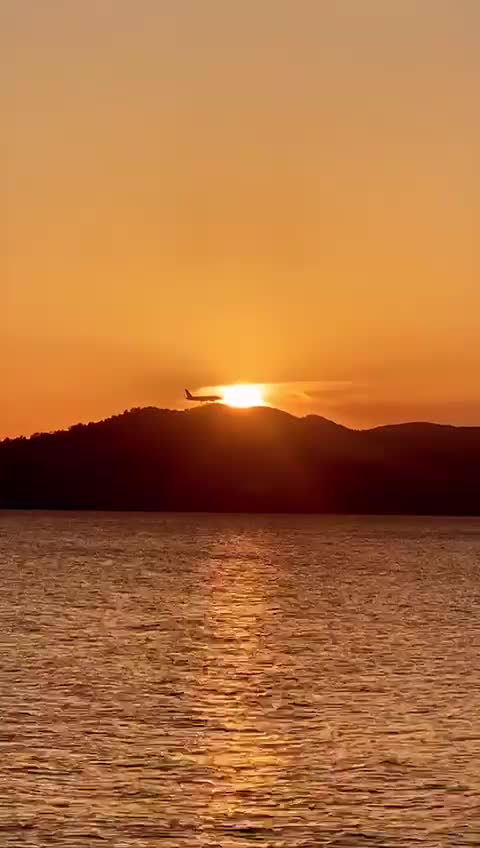Plane going through sunset for website