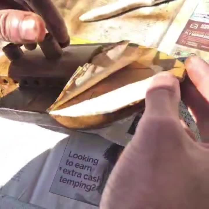 Peeling masking tape from boat model